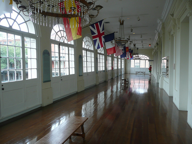 The gallery inside of the historic Cabildo displays the flags of those who have ruled in New Orleans. (Photo via Flickr user Tom Bastin)