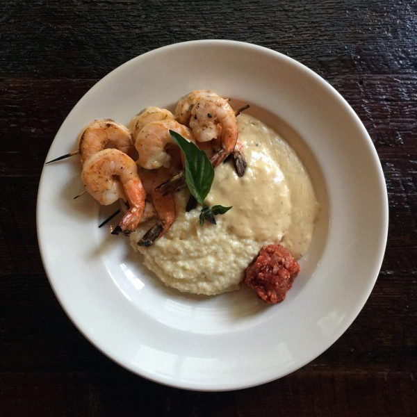 Sambal Shrimp and Grits is served with savory pork gravy and sweet bacon jam. Find it at Latitude 29 bar and restaurant, inside Bienville House Hotel in the French Quarter of New Orleans.
